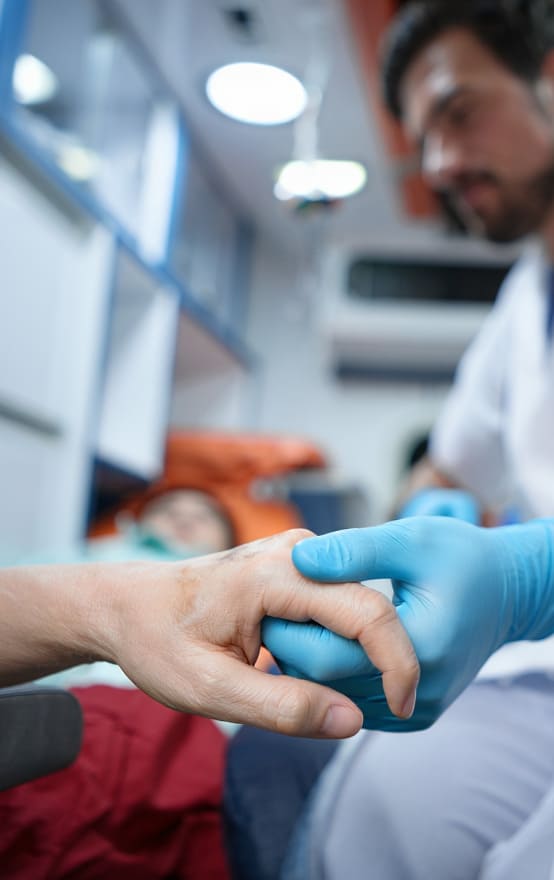 Врач держит пациента за руку